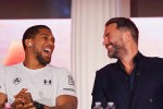 Anthony Joshua and Eddie Hearn laughing together.