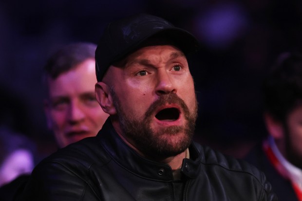 Tyson Fury reacting at a boxing match.